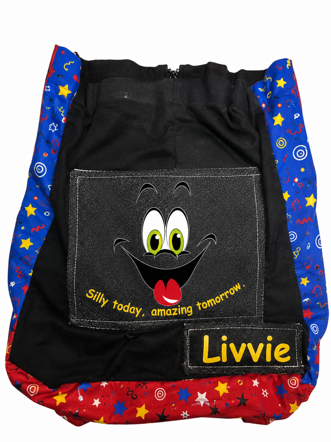 A custom black backpack with colorful patterned side and bottom panels, featuring a large cartoon face graphic on the front pocket and a name patch that reads 'Livvie'.