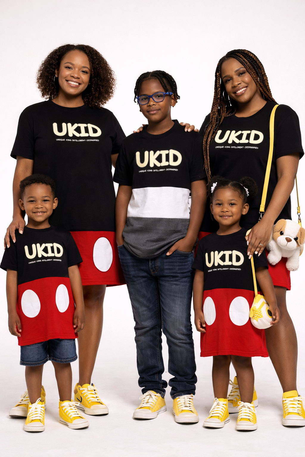 Family wearing matching 'UKID' shirts with a white background